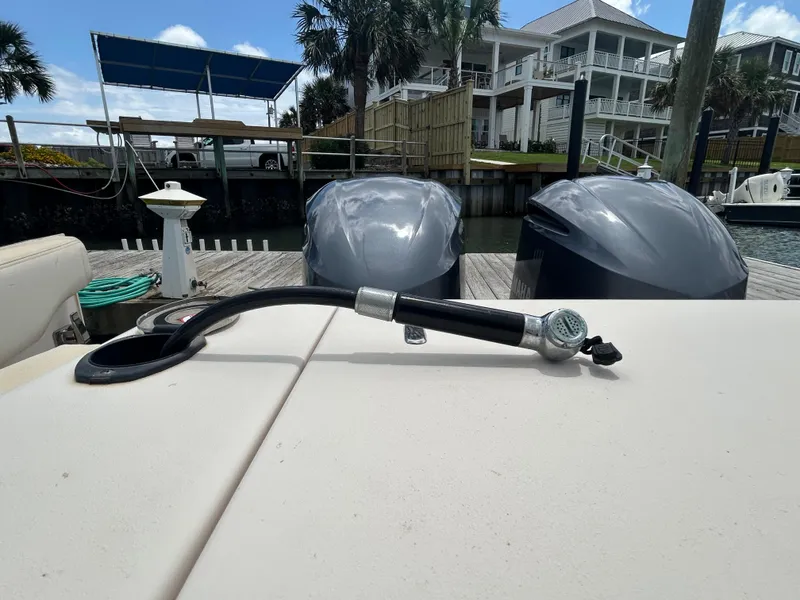 Slide: The Image of 2019 Grady-White Canyon 306 boat with dual Yamaha outboard motors at a dock. - 4