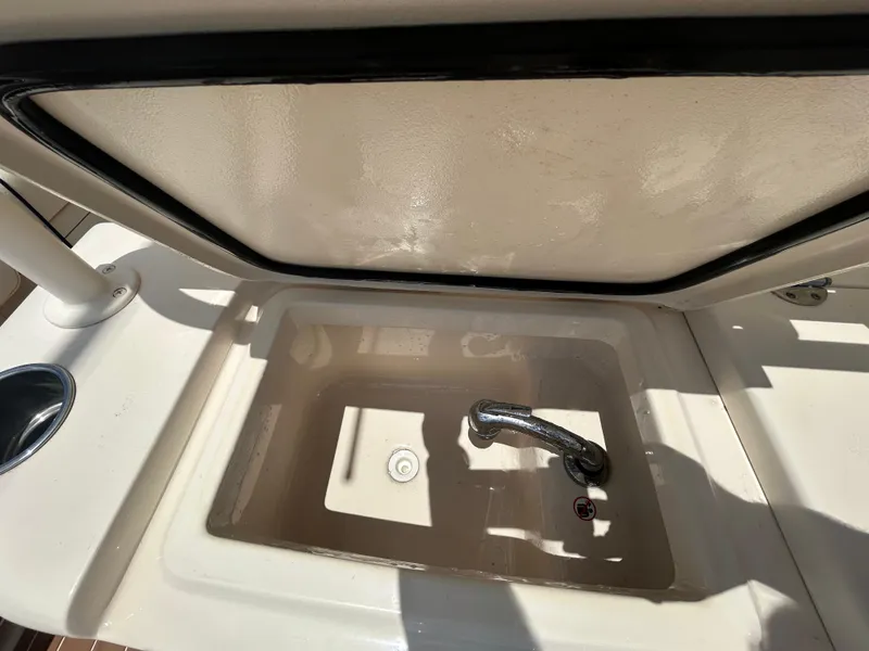 Slide: The Image of 2019 Grady-White Canyon 306 boat sink with faucet, open lid, and cup holder. - 8