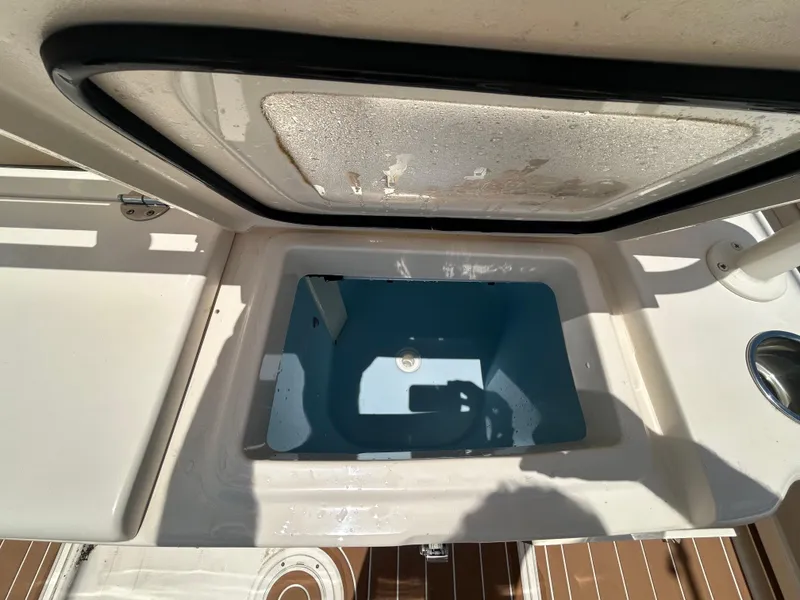Slide: The Image of Open storage compartment on 2019 Grady-White Canyon 306 boat, showing interior details. - 9