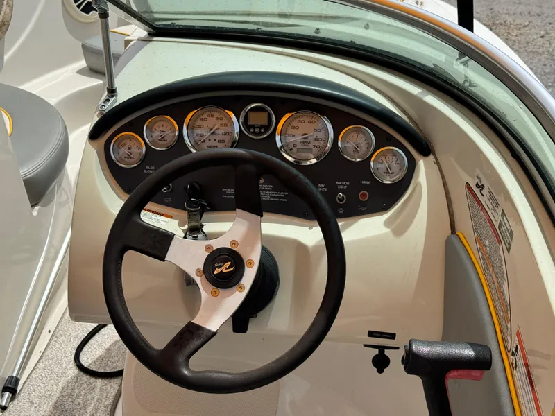 Slide: The Image of Dashboard of a 2008 Sea Ray 185 Sport boat with steering wheel and gauges. - 11