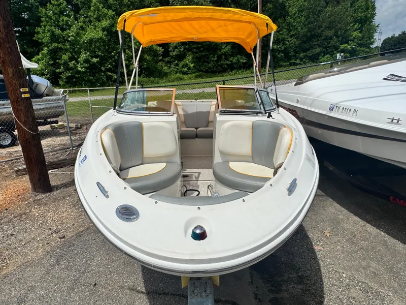 Slide: The Image of 2008 Sea Ray 185 Sport boat with yellow canopy, parked outdoors. - 3