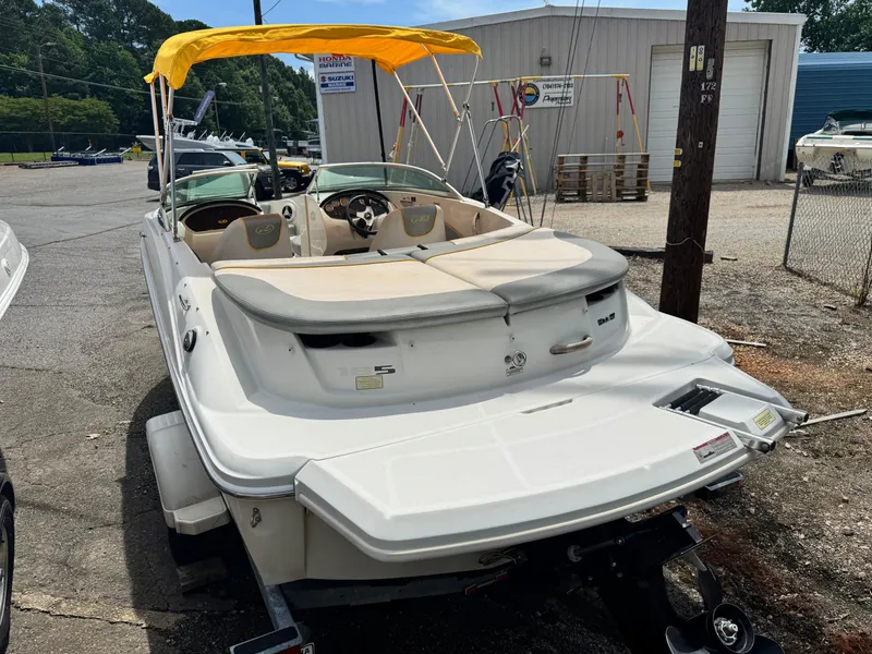 Slide: The Image of 2008 Sea Ray 185 Sport boat with yellow canopy, parked outdoors. - 5