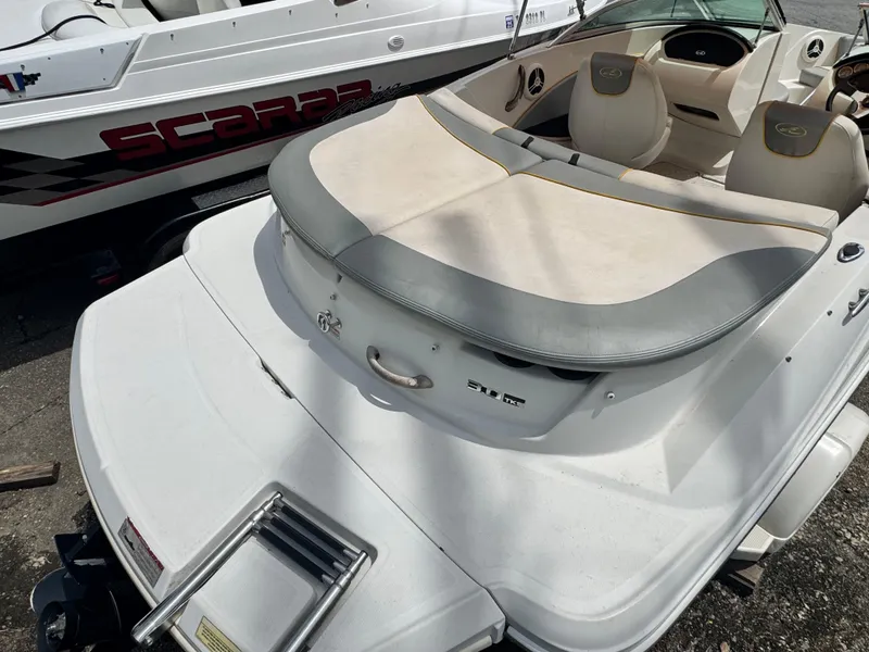 Slide: The Image of 2008 Sea Ray 185 Sport boat with seating and swim platform, parked beside another boat. - 8
