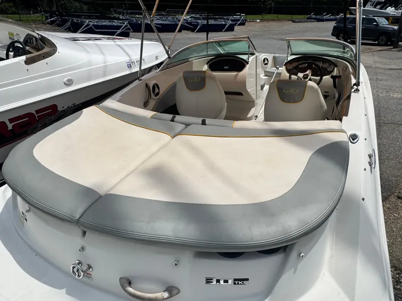 Slide: The Image of 2008 Sea Ray 185 Sport boat interior with seating and dashboard, parked outdoors. - 9