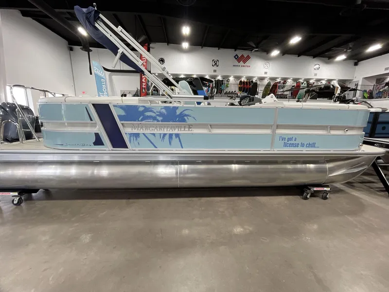Slide: The Image of 2025 South Bay S224 Chill pontoon boat with Margaritaville theme in showroom. - 11