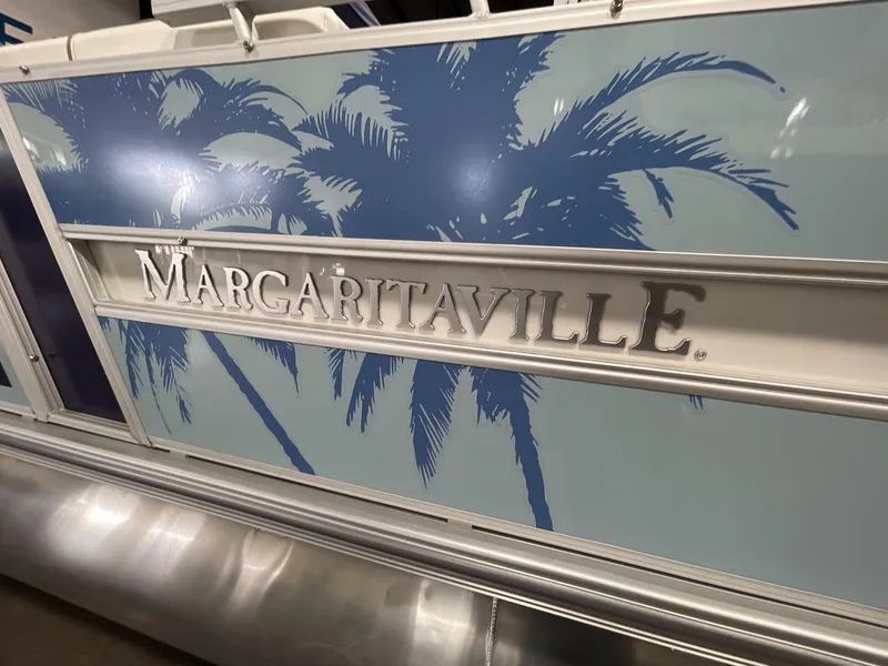 Slide: The Image of 2025 South Bay S224 Chill boat with Margaritaville branding and palm tree design. - 13