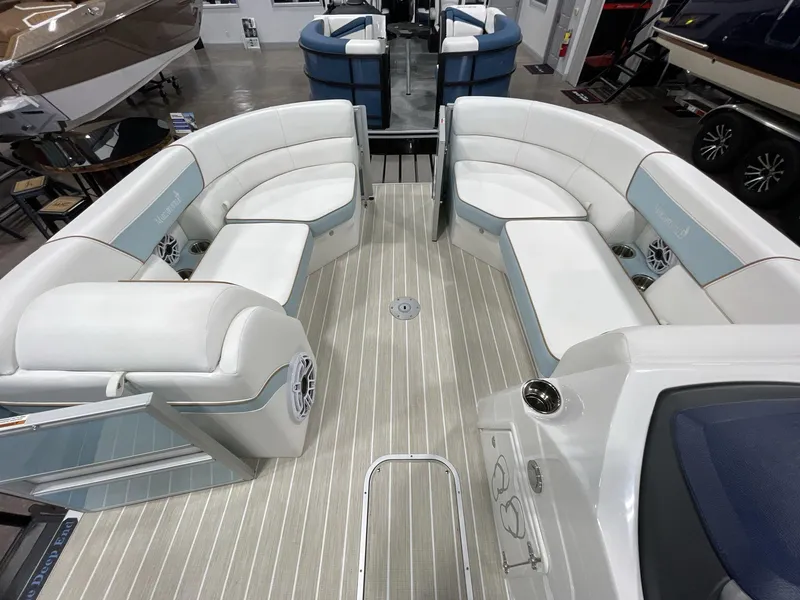 Slide: The Image of 2025 South Bay S224 Chill pontoon boat interior with white seating and wood-style flooring. - 16