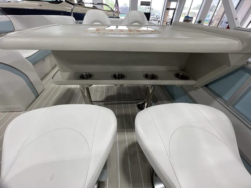 Slide: The Image of Interior of 2025 South Bay S224 Chill boat with seating and table setup. - 17