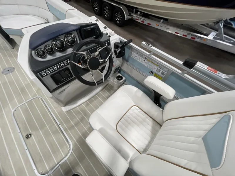 Slide: The Image of 2025 South Bay S224 Chill boat interior with steering wheel and control panel. - 20