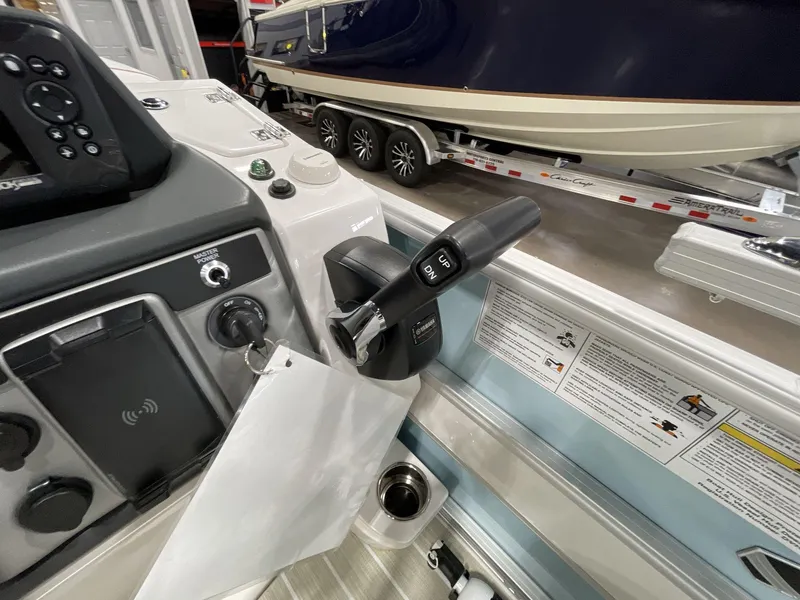 Slide: The Image of Control panel of 2025 South Bay S224 Chill boat, featuring throttle and ignition. - 21