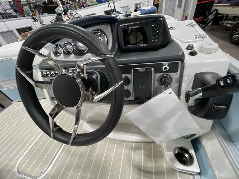 Slide: The Image of Steering console of 2025 South Bay S224 Chill boat with modern controls and display. - 22