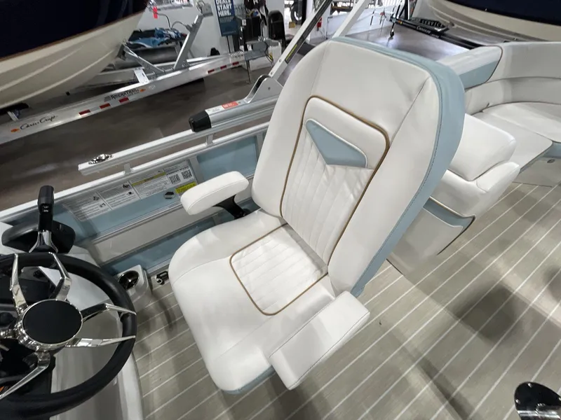 Slide: The Image of 2025 South Bay S224 Chill boat interior with luxurious white seating and steering wheel. - 23