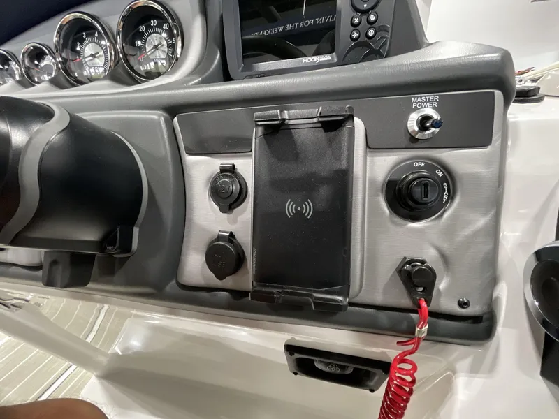 Slide: The Image of Control panel of 2025 South Bay S224 Chill boat with gauges and switches. - 24