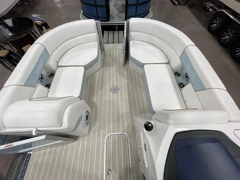 Slide: The Image of 2025 South Bay S224 Chill pontoon boat interior with white seating and wood-style flooring. - 25