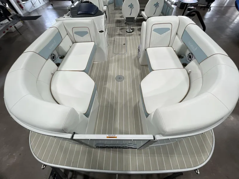 Slide: The Image of 2025 South Bay S224 Chill boat interior with white seating and wood-style flooring. - 26
