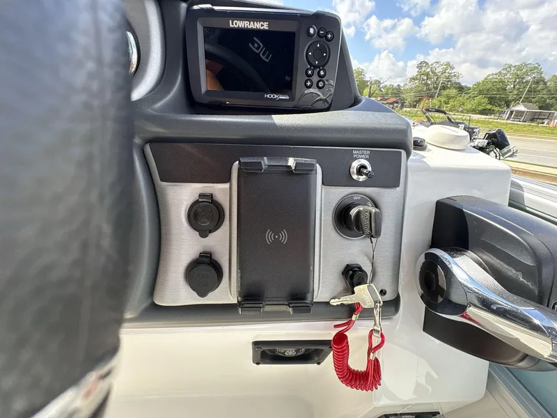 Slide: The Image of Control panel of 2025 South Bay S224 Chill boat with Lowrance display and ignition keys. - 28