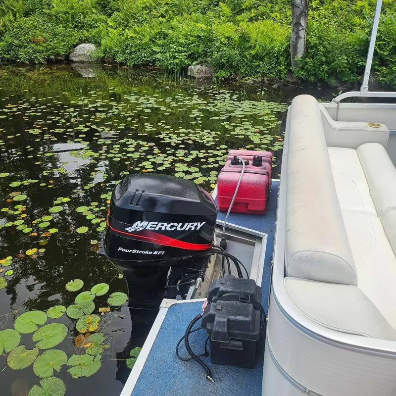 Slide: The Image of 2003 Starcraft Cruise 180 boat with Mercury engine on a lily pad-covered lake. - 5