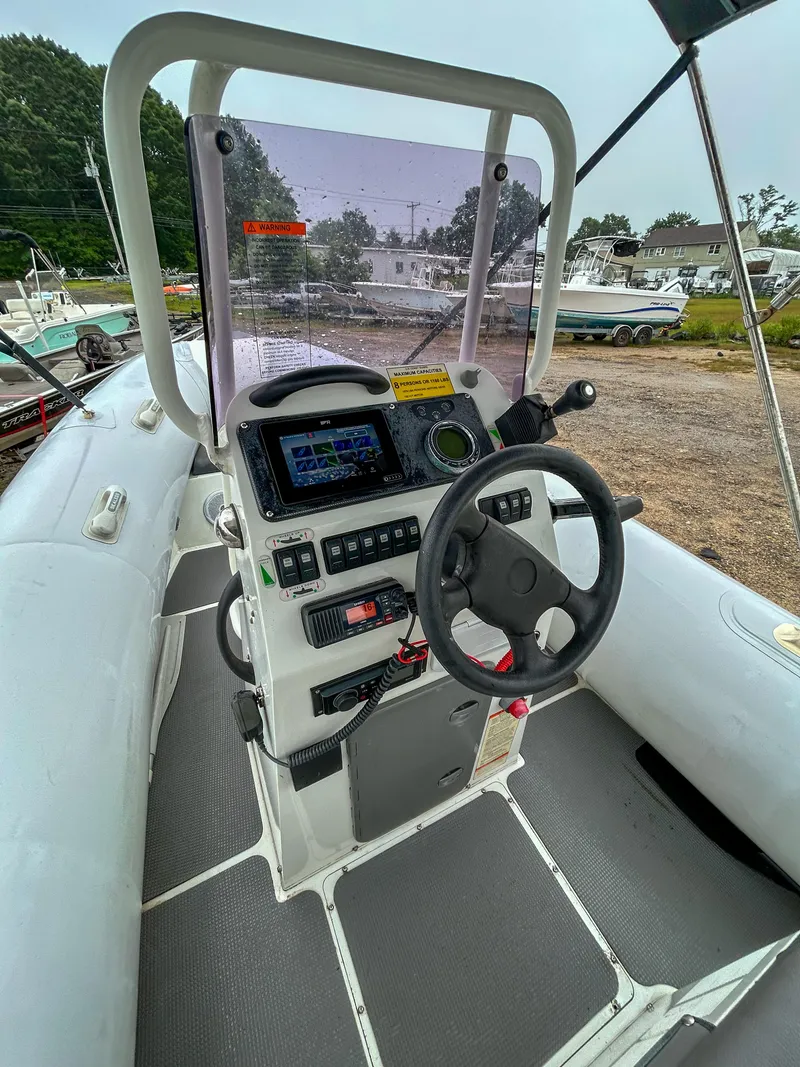 Slide: The Image of 2014 Sealegs 7.1m RIB boat cockpit with steering wheel and control panel. - 6