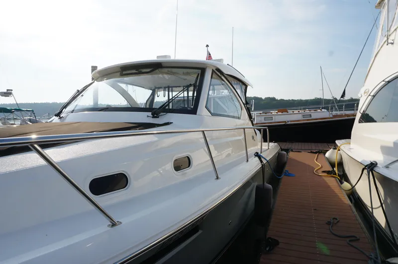 Slide: The Image of 2023 Pursuit OS 355 Offshore boat docked at marina, side view. - 10