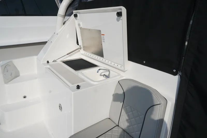 Slide: The Image of 2023 Pursuit OS 355 Offshore boat interior with sink and seating area. - 18
