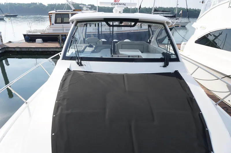 Slide: The Image of 2023 Pursuit OS 355 Offshore boat docked, featuring sleek design and spacious cockpit. - 23