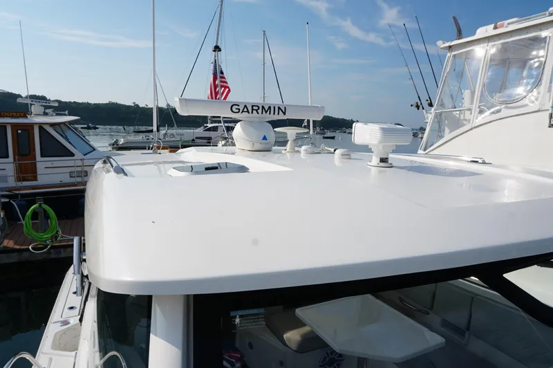 Slide: The Image of 2023 Pursuit OS 355 Offshore boat with Garmin equipment docked at marina. - 25