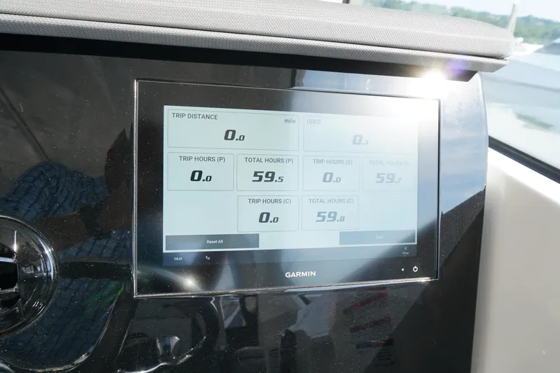 Slide: The Image of Garmin display on 2023 Pursuit OS 355 Offshore showing trip and total hours. - 28