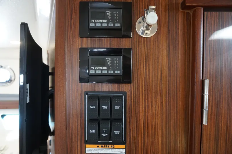 Slide: The Image of Control panel on 2023 Pursuit OS 355 Offshore boat, featuring Dometic systems and switches. - 31