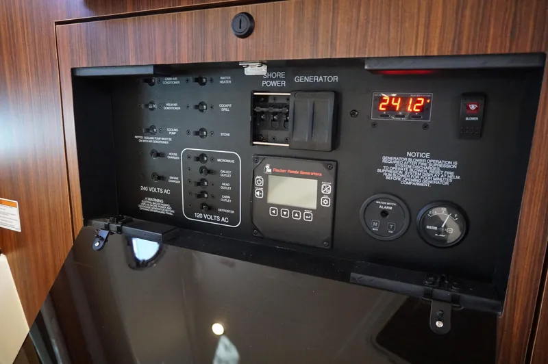 Slide: The Image of Electrical control panel of 2023 Pursuit OS 355 Offshore boat, featuring power switches and gauges. - 33