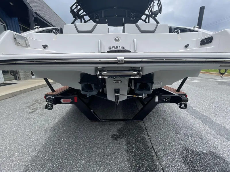 Slide: The Image of Rear view of a 2024 Yamaha Boats 252XE on a trailer, showcasing dual engines. - 13