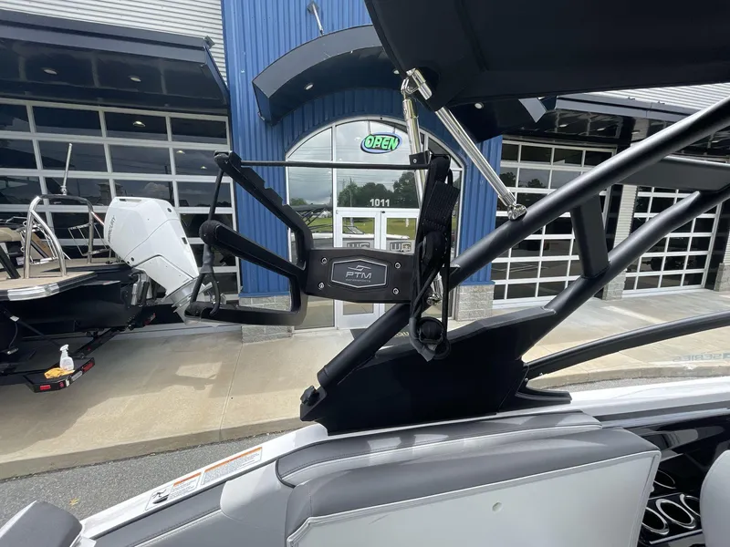 Slide: The Image of 2024 Yamaha Boats 252XE with advanced wakeboard tower, displayed outside a showroom. - 21