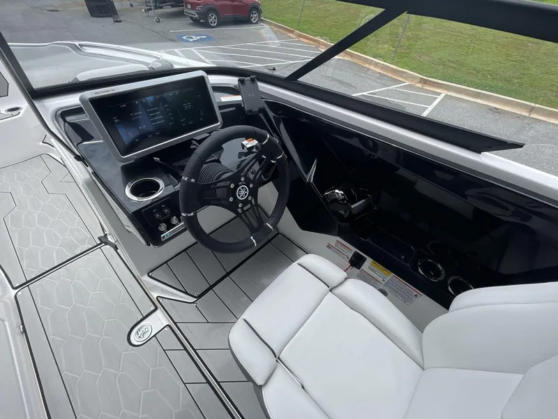 Slide: The Image of 2024 Yamaha Boats 252XE cockpit with modern steering and digital display. - 26