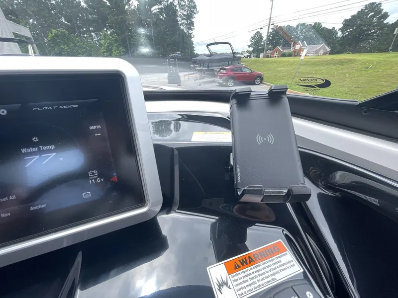 Slide: The Image of 2024 Yamaha Boats 252XE dashboard with touchscreen display and phone holder. - 30