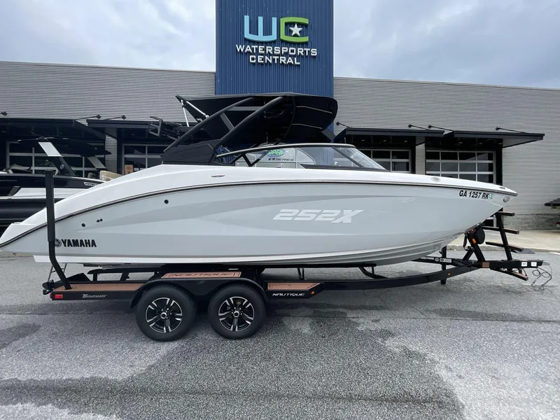 Slide: The Image of 2024 Yamaha Boats 252XE on trailer at Watersports Central dealership. - 6