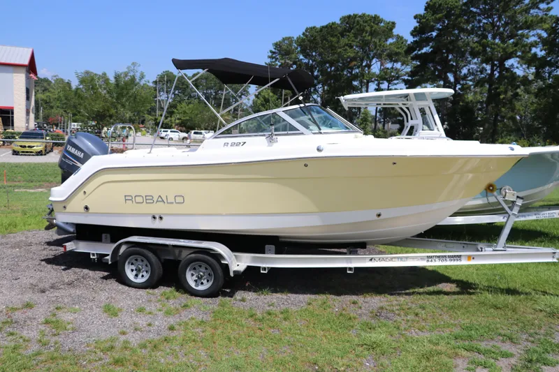 Slide: The Image of 2008 Robalo R227 Dual Console boat on trailer, parked outdoors. - 0