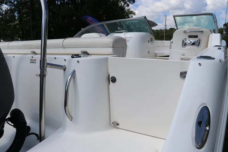 Slide: The Image of 2008 Robalo R227 Dual Console boat interior with open seating and stainless steel fixtures. - 10