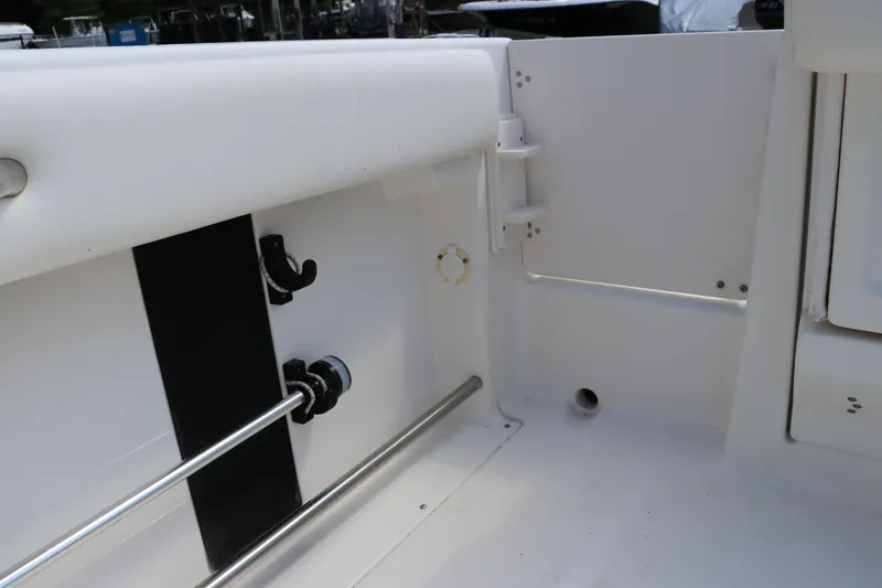 Slide: The Image of 2008 Robalo R227 Dual Console boat interior, featuring rod holders and storage compartments. - 12