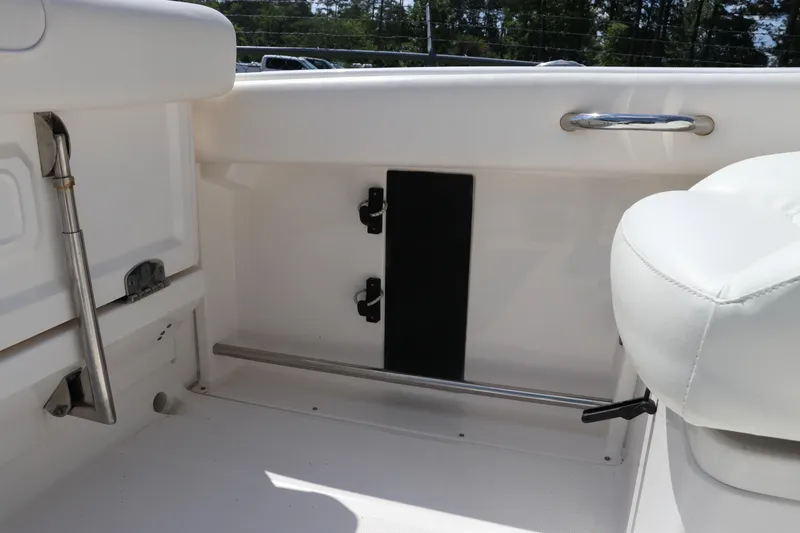 Slide: The Image of 2008 Robalo R227 Dual Console interior with white seating and stainless steel fixtures. - 15