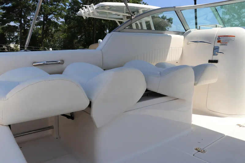Slide: The Image of 2008 Robalo R227 Dual Console boat interior with white cushioned seating and sleek design. - 18