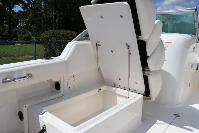 Slide: The Image of 2008 Robalo R227 Dual Console boat with open storage compartment and seating. - 19