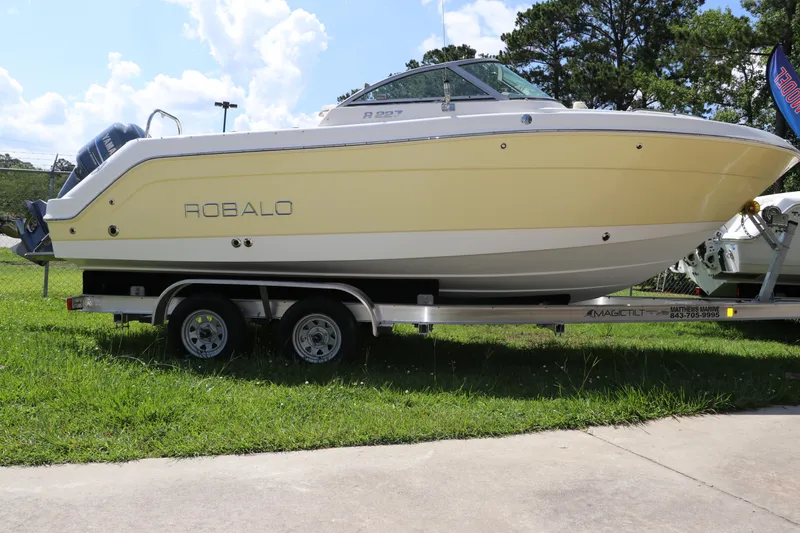 Slide: The Image of 2008 Robalo R227 Dual Console boat on trailer, parked on grass. - 2