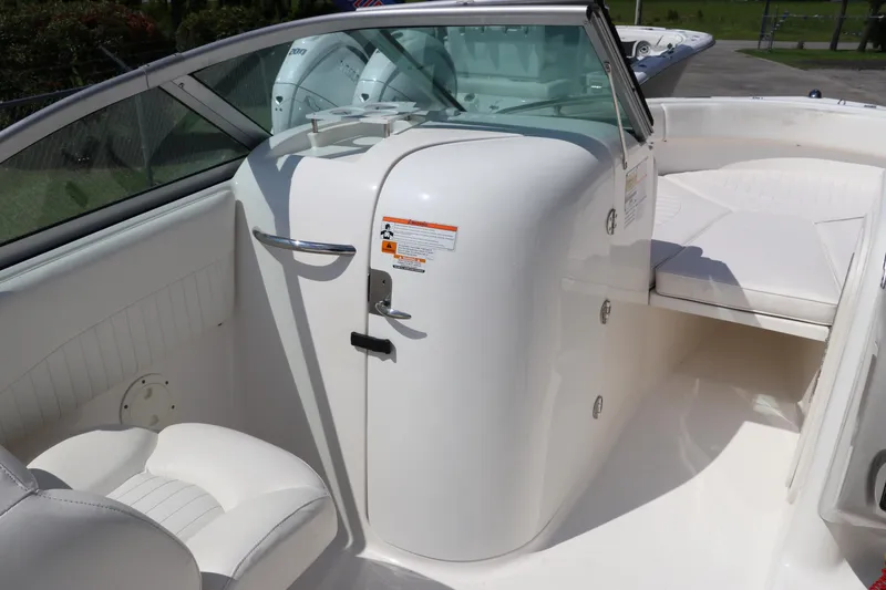 Slide: The Image of 2008 Robalo R227 Dual Console boat interior with white seating and storage compartment. - 20