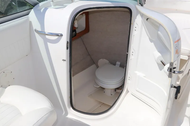 Slide: The Image of 2008 Robalo R227 Dual Console boat interior with open restroom door. - 22