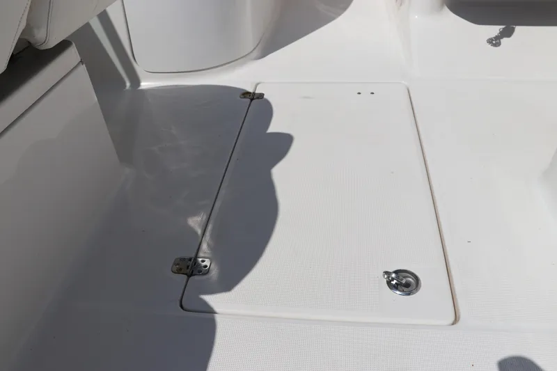 Slide: The Image of 2008 Robalo R227 Dual Console boat deck with storage hatch and latch. - 25