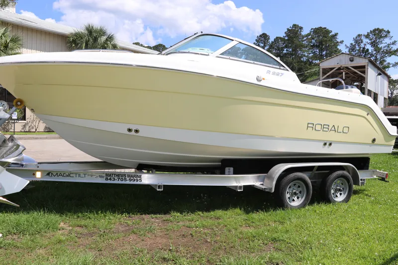 Slide: The Image of 2008 Robalo R227 Dual Console boat on trailer, parked on grass. - 3