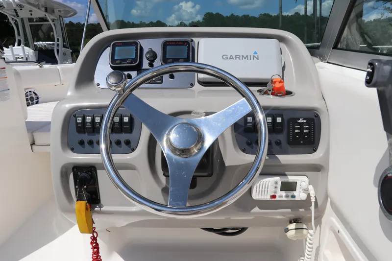 Slide: The Image of 2008 Robalo R227 Dual Console dashboard with Garmin navigation and steering wheel. - 30