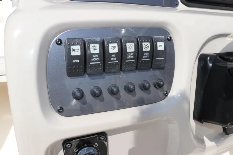 Slide: The Image of Control panel of 2008 Robalo R227 Dual Console boat with labeled switches. - 32