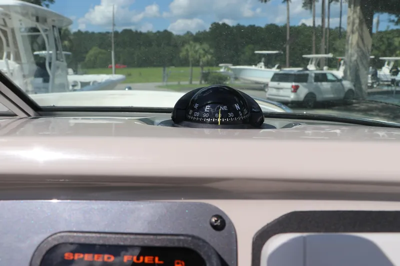Slide: The Image of 2008 Robalo R227 Dual Console dashboard with compass and speed fuel display. - 35