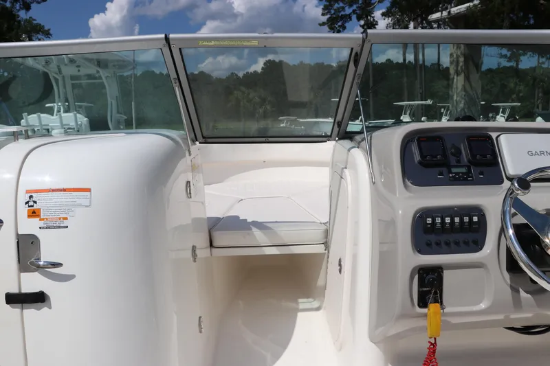 Slide: The Image of 2008 Robalo R227 Dual Console boat interior with steering controls and seating area. - 37