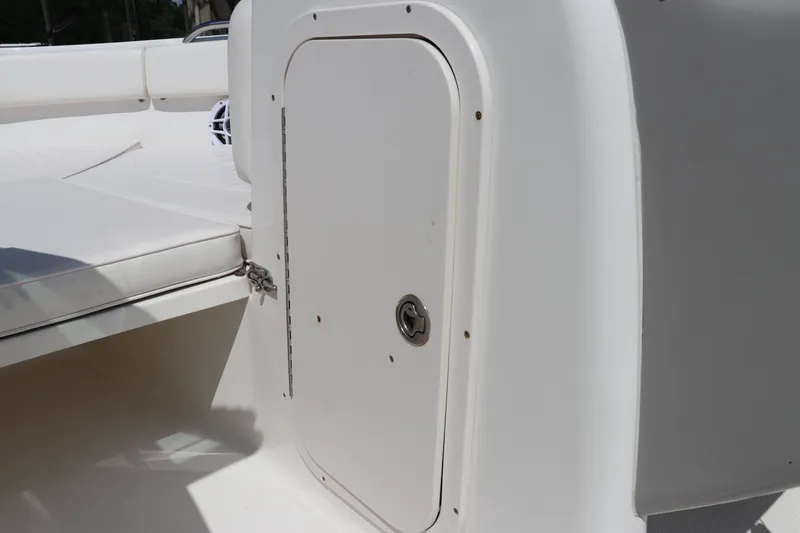 Slide: The Image of 2008 Robalo R227 Dual Console boat storage compartment and seating area. - 38